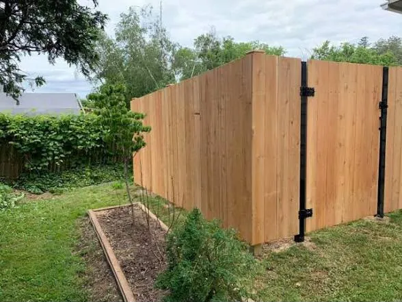 Cedar fence framing with rails visible during installation