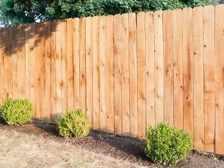 Cedar privacy fence along a planted bed